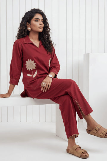 Effortlessly blend comfort with artistry in this stunning co-ord set, featuring a hand-crafted sunflower appliqué that makes every outfit a statement. The relaxed-fit tunic top comes with a classic collar, 3/4 sleeves with cuffed ends, front patch pockets